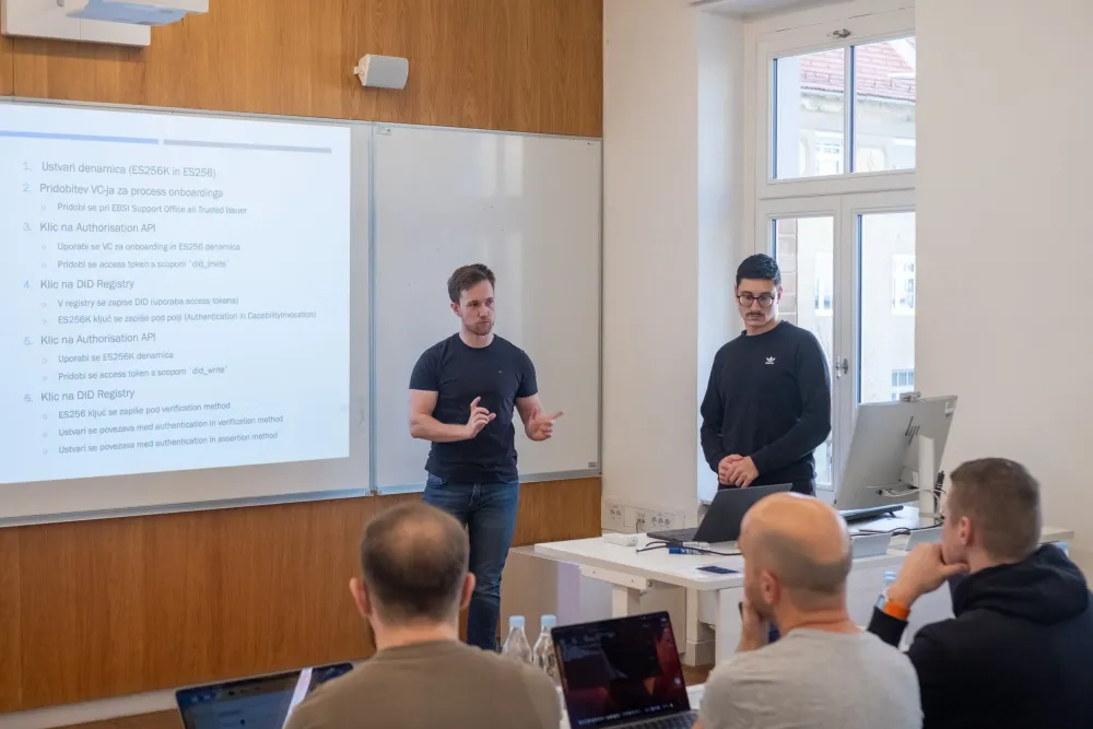 Two presenters at the front of a classroom during the FERI workshop.